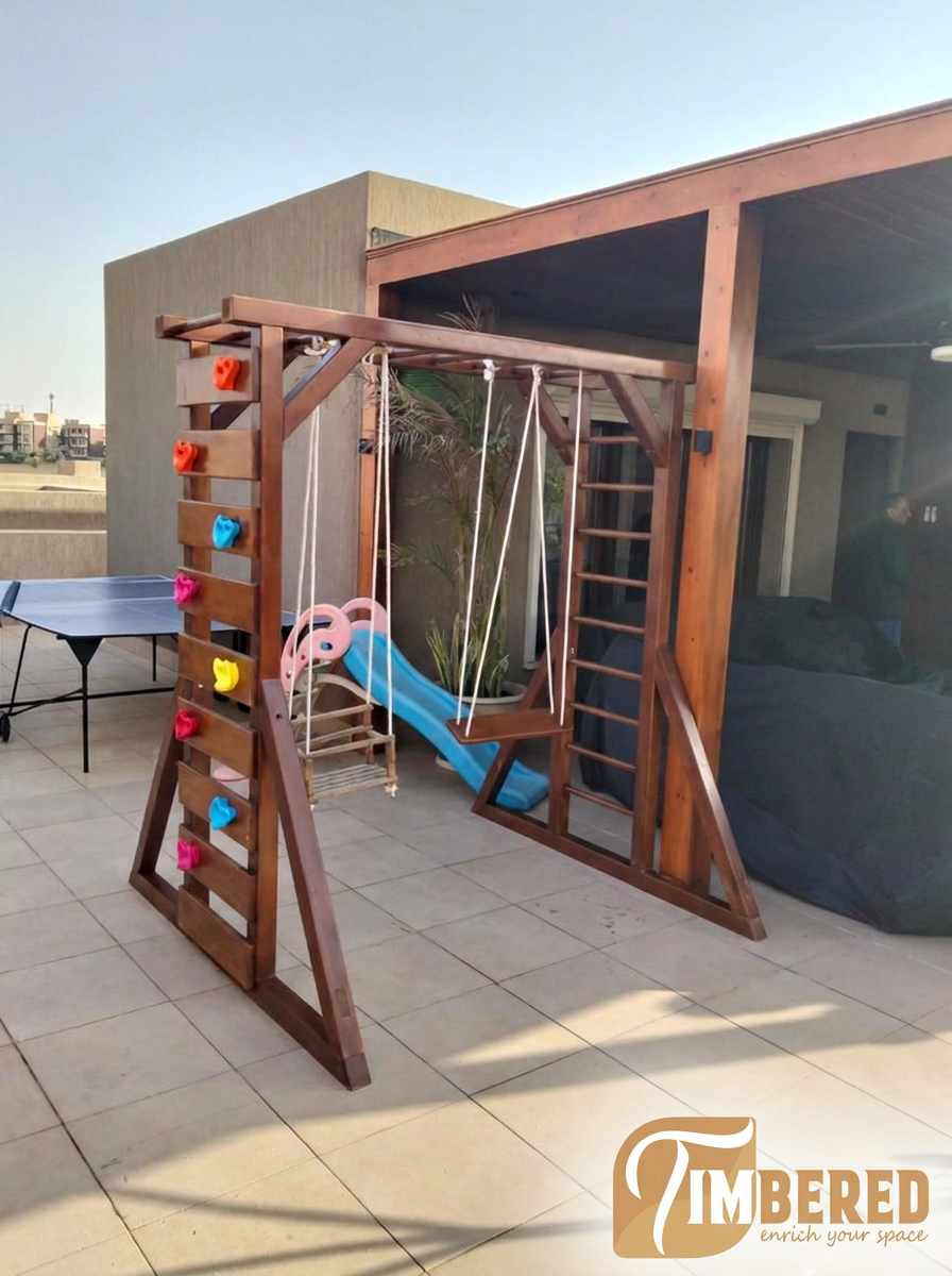 Twin Swing Play Frame installed on a customer rooftop - side view with climbing wall